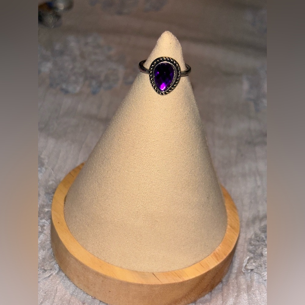 Silver ring with purple stone
Size 8